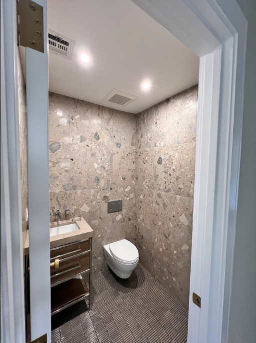 Powder room with patterned statement tile and a compact vanity